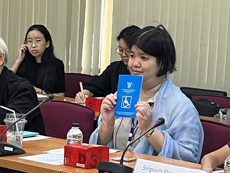5. APCD's Networking & Collaboration Officer displays Thai decree on disability protection and empowerment.