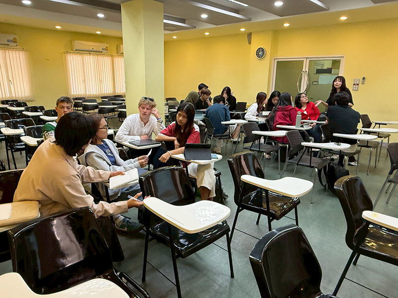 Students participate in a group activity during the session, actively discussing and working on assigned tasks while the APCD representative provides explanations, guidance, and further clarification to support their learning.