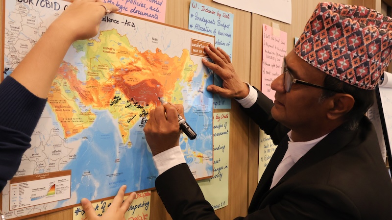 Photo 7: The participants signed on the map of Asia all together as a symbol for the collaboration on CBR/CBID CoE and movement in Asia.